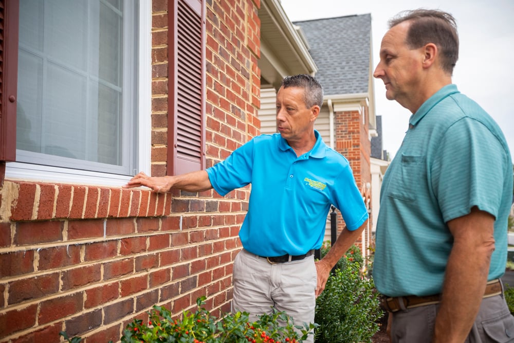 Pest control technician discussing entry points for pests