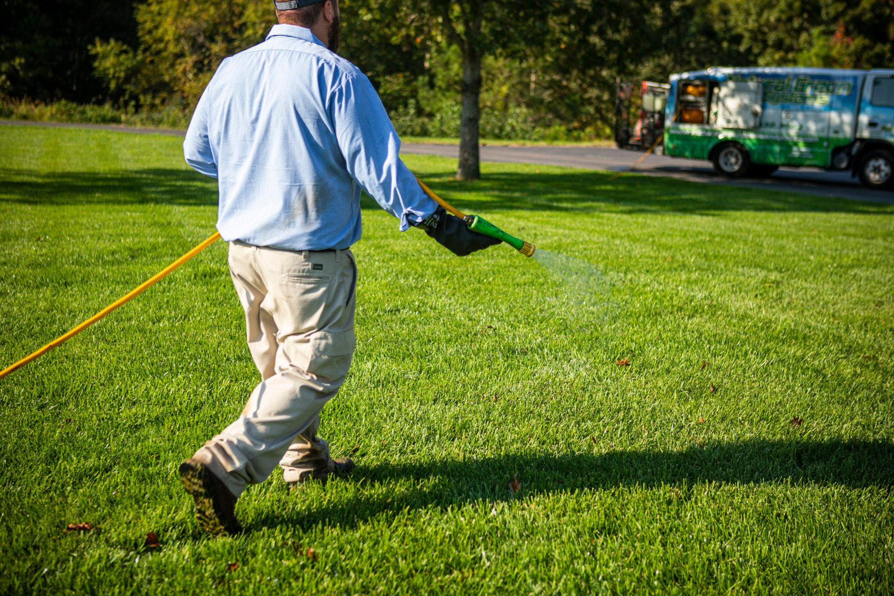 lawn technician spraying weed control