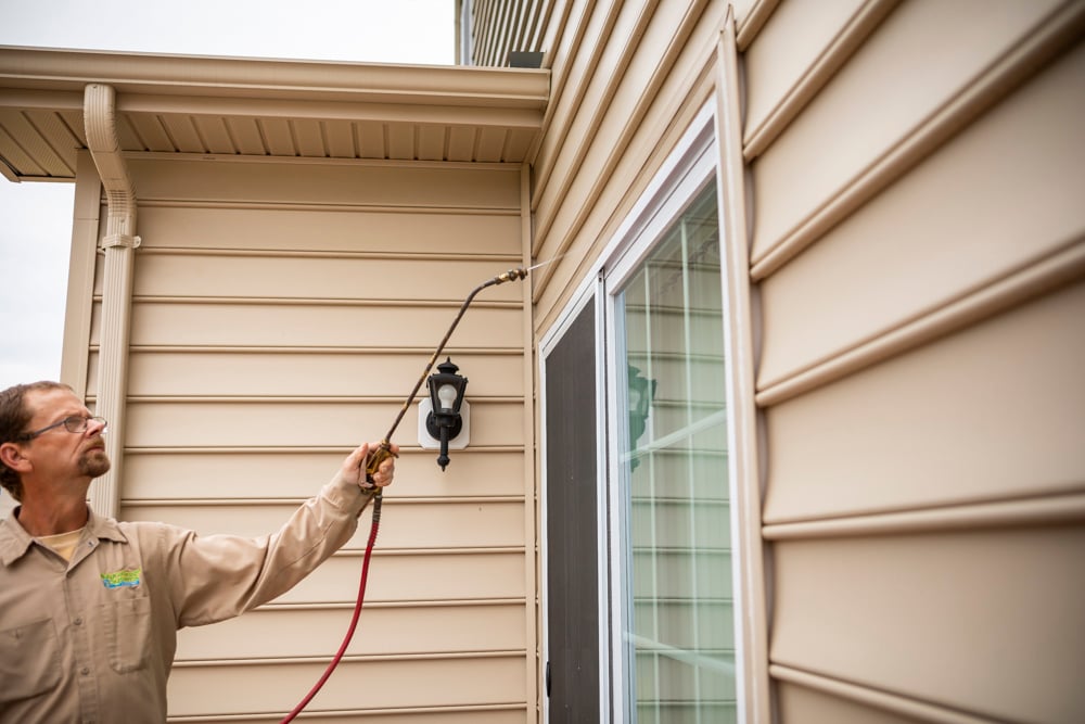 Natural Green team spraying a house for pests