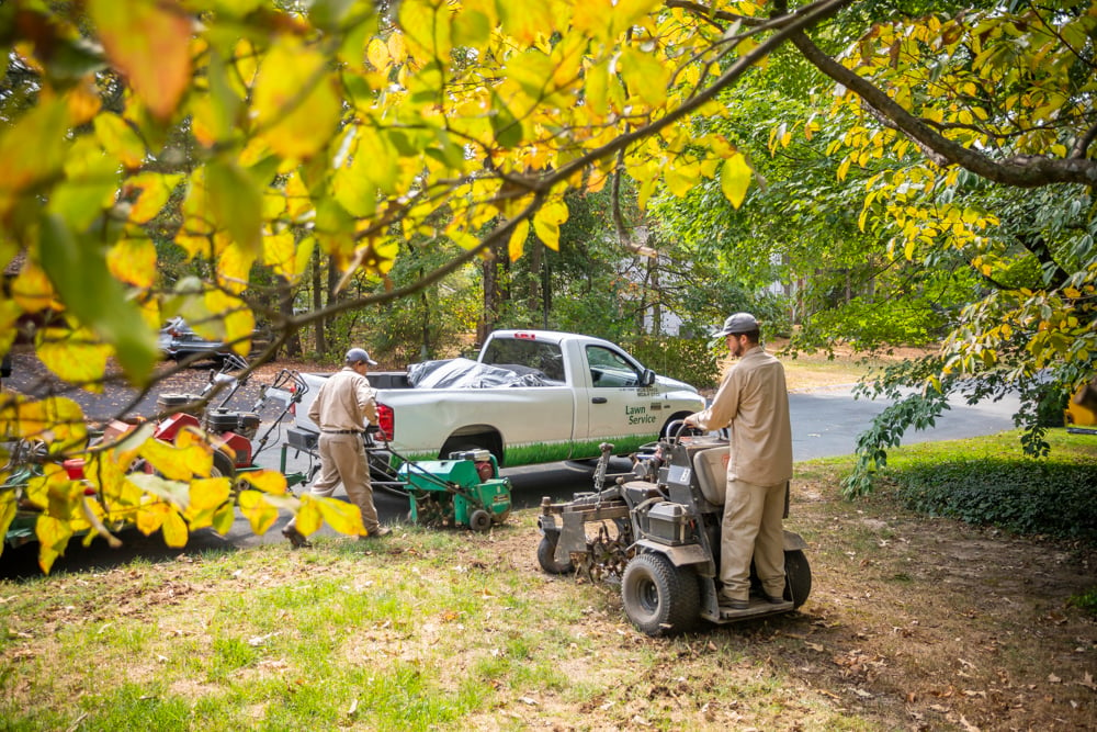 Lawn care team aerating to prevent inscts