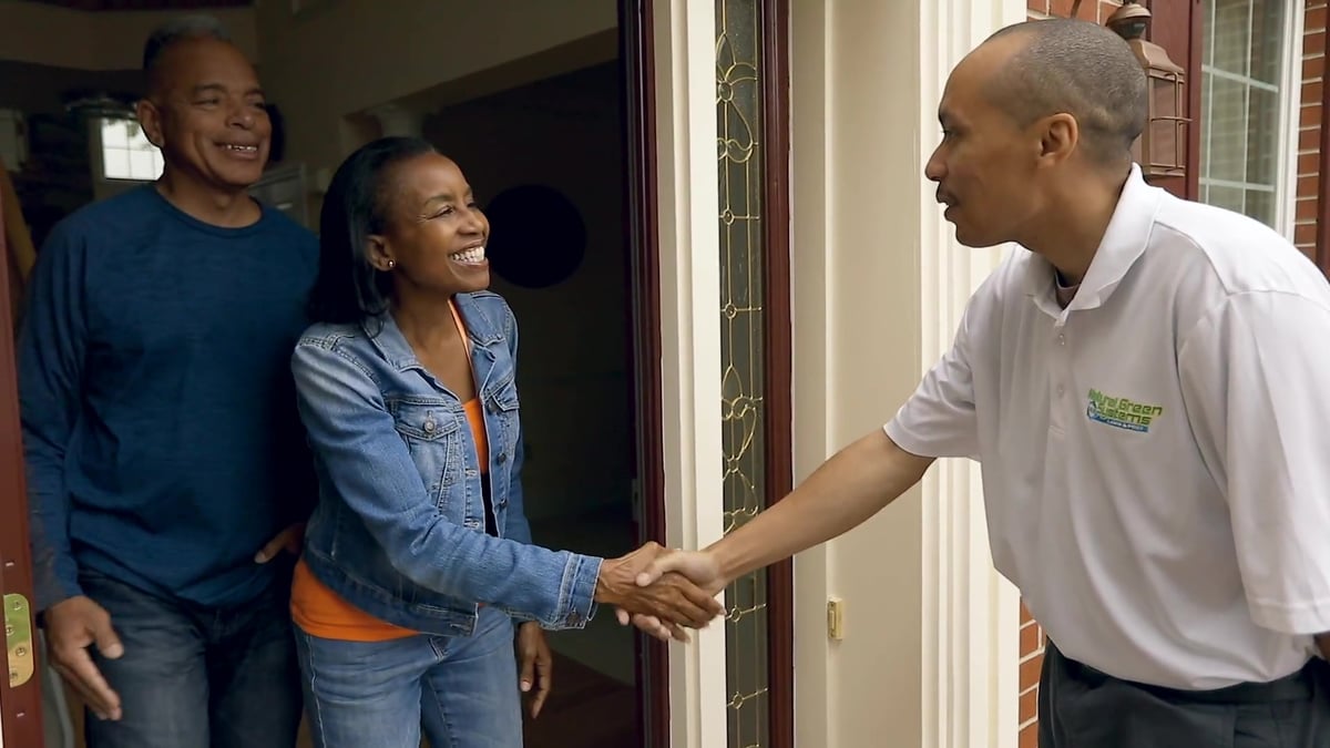 pest control expert shakes hands with customers