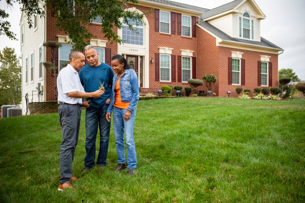 professional lawn care technician helping customers in lawn