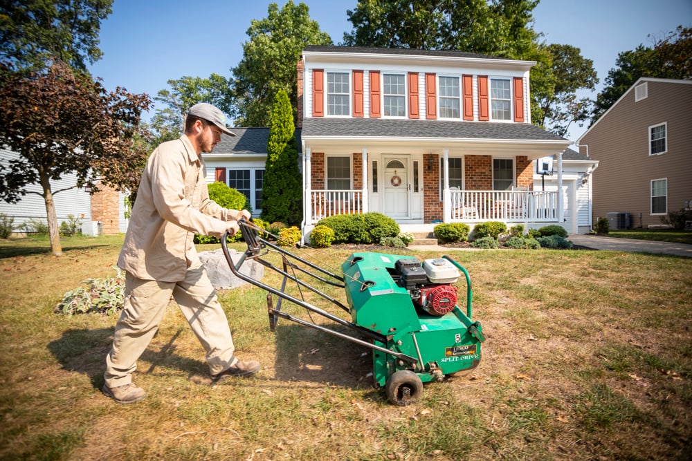 lawn care team aerates lawn