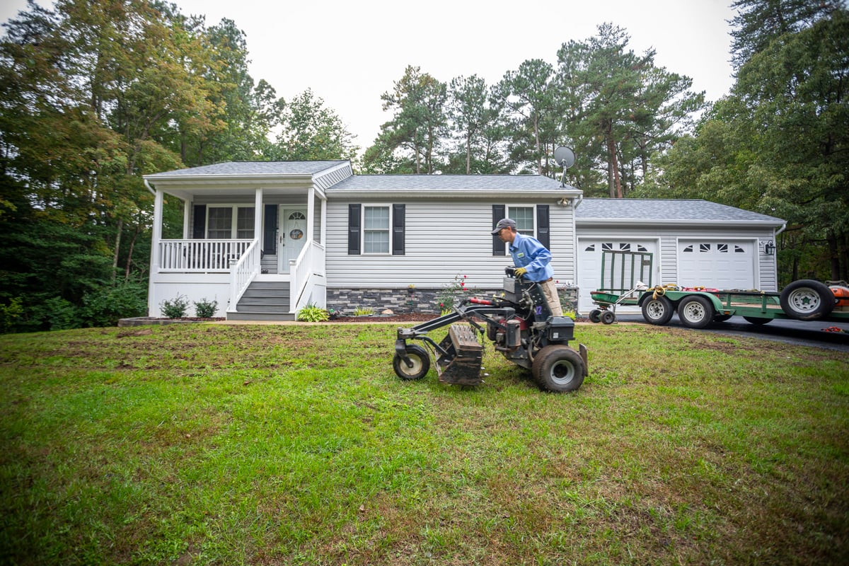 lawn care professional aerating lawn