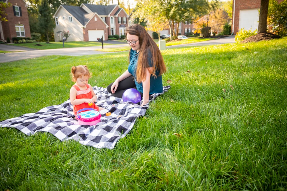 Family in yard safe from mosquitoes with mosquito control services