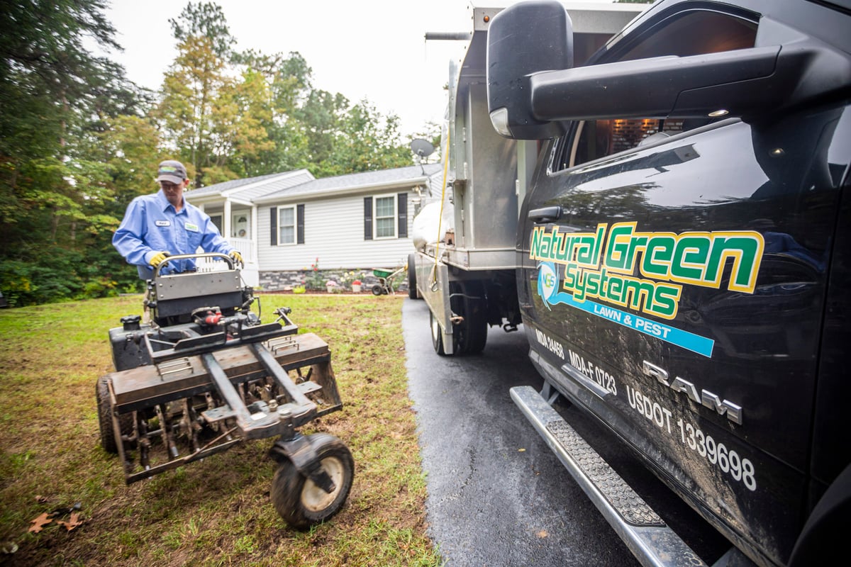 landscape professional aerates lawn